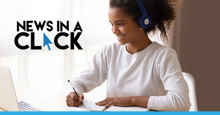 Student studying at desk with headphones on