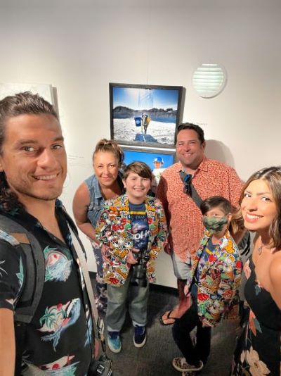 The Cardoza and Borden family in front of Aiden’s project photos at the Orlando Science Center