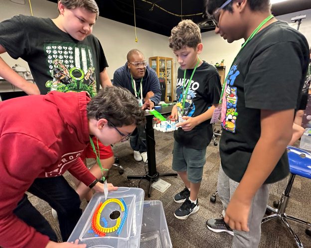 A group of students working a project at the STEM Camp