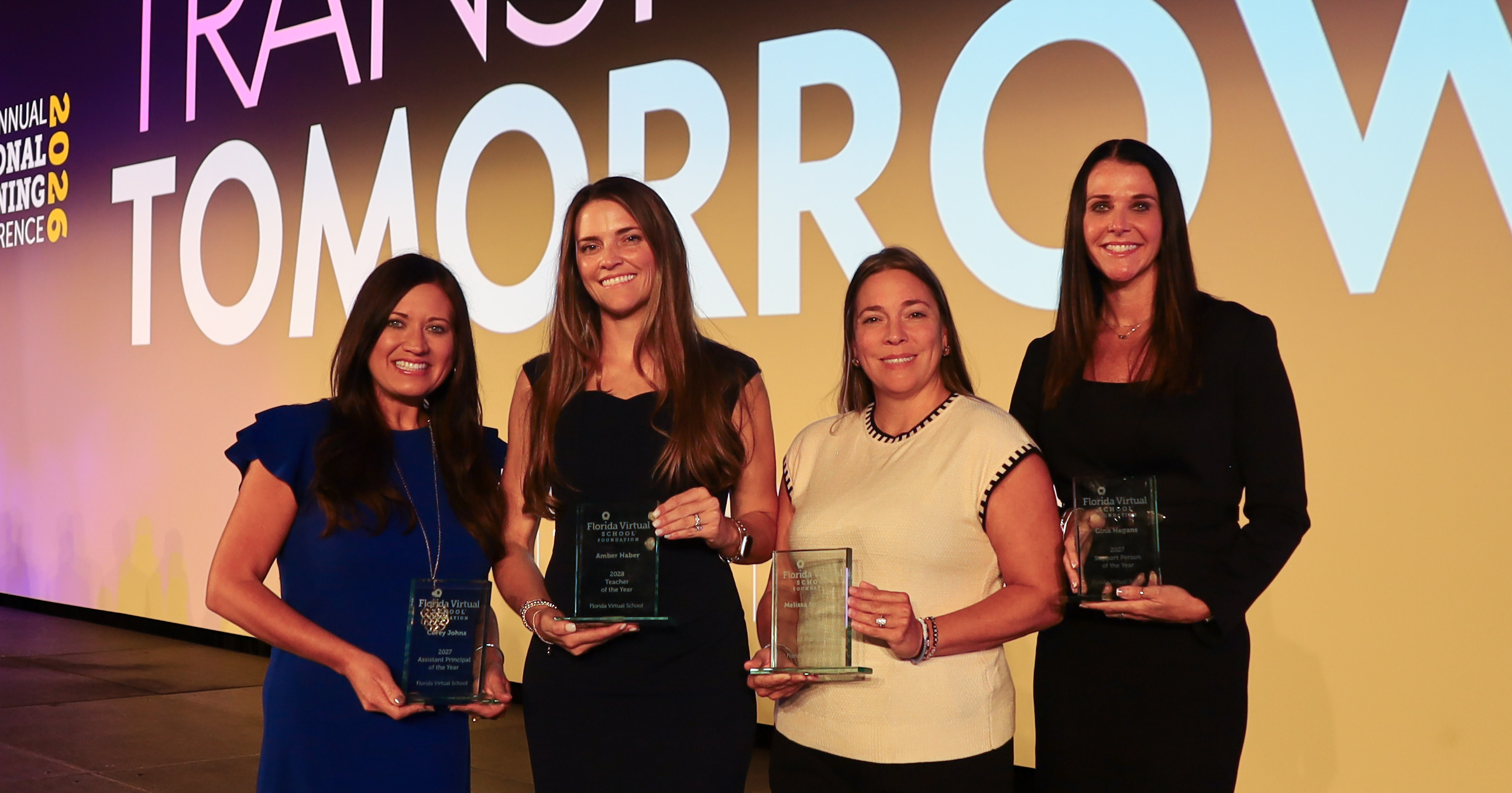 FLVS names 2026-27 Team Members of the Year Four team members of the year stand on stage with their awards