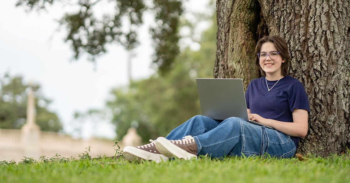 Florida Students Can Build Life Skills This Summer Through Tuition-Free Online Courses A Florida student works on a laptop outdoors.