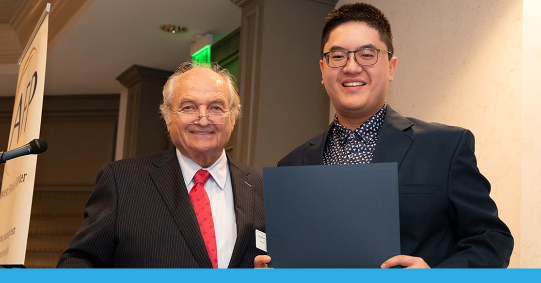 Florida Virtual High School Senior Honored for Outstanding Community Impact Alvin Luu stands indoors holding his certificate for his the Youth in Philanthropy Award.