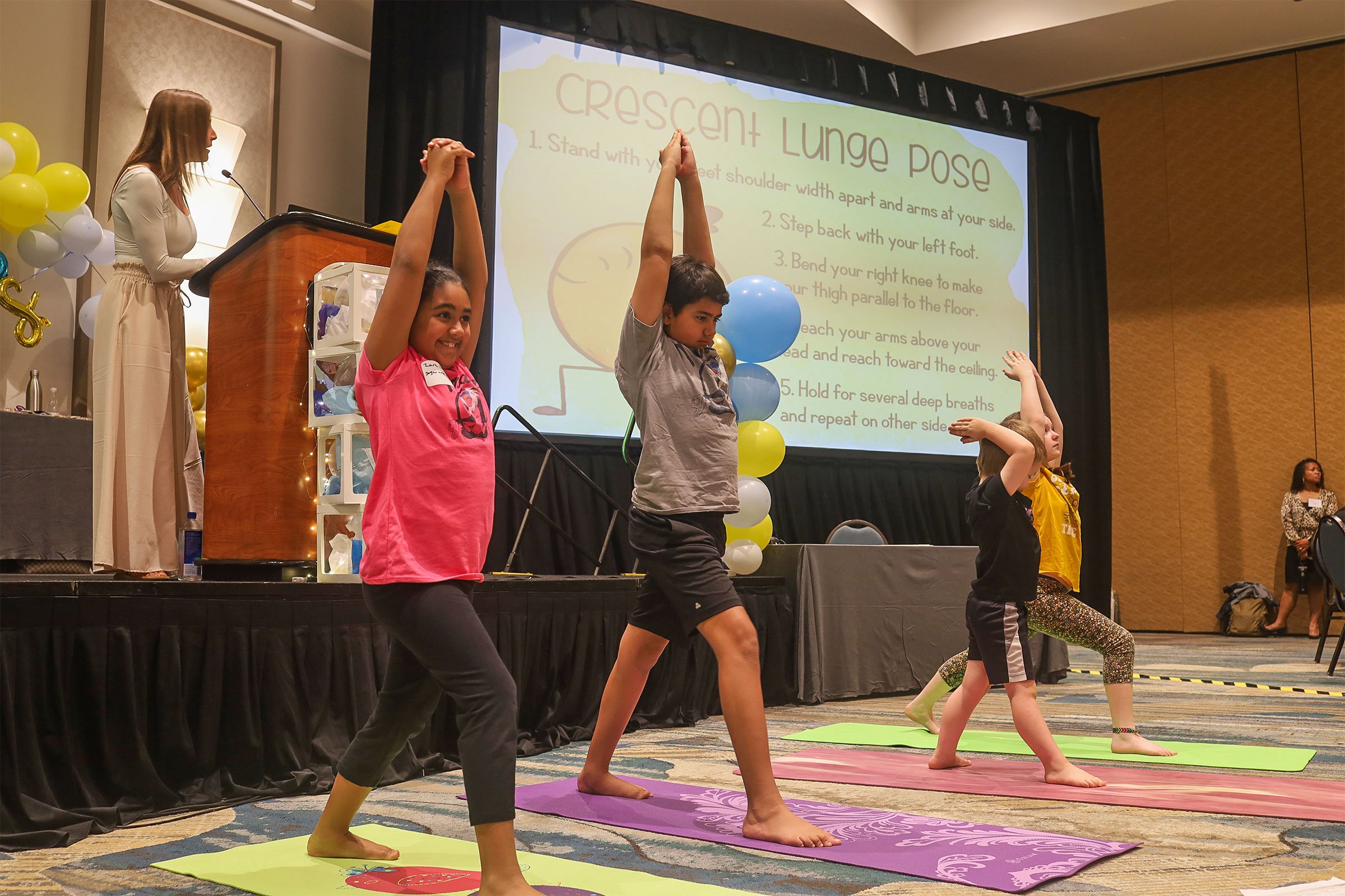 Elementary students perform yoga routines at the annual FLVS club awards.