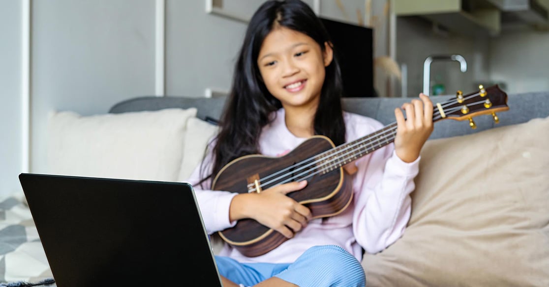 Small Sounds, Big Discoveries: How Young Learners Explore Music at Florida Virtual School A student uses a small string instrument as part of an online music activity