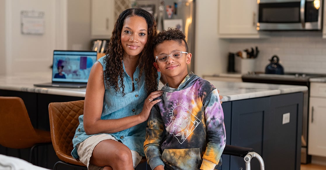 Understanding FLVS Full Time Public School Enrollment: What Families Need to Know An adult sits beside a child engaged in full time online learning at home, representing a structured virtual public school environment through FLVS Full Time.