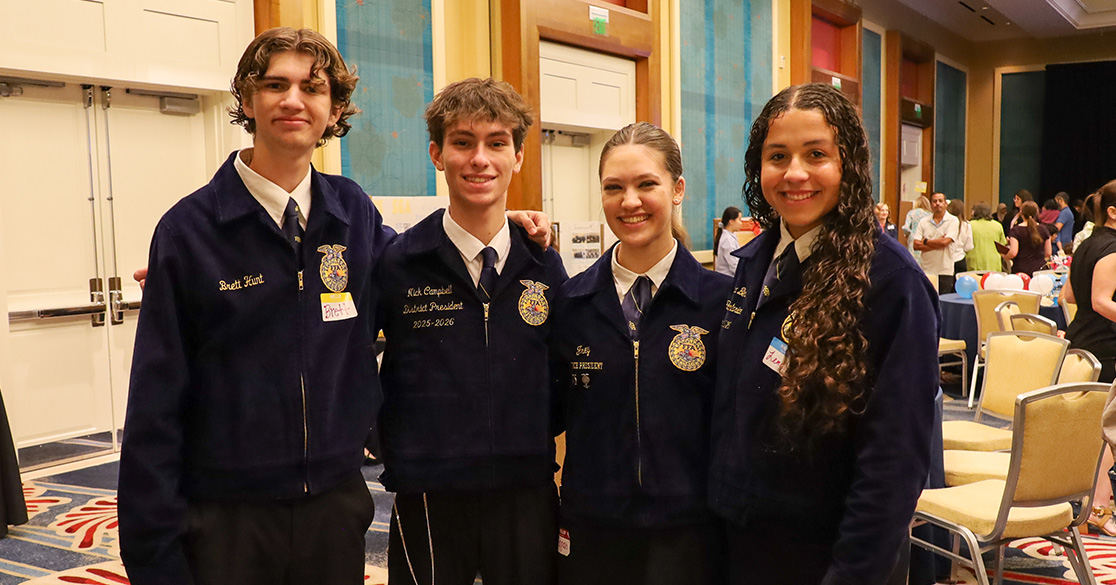 Virtual Students Gather in Orlando for Statewide Club Awards Event Four FLVS Future Farmers of America club members stand together in their club uniforms in a large ballroom at the annual FLVS Club Awards.