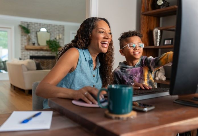 Student checking grades with parent